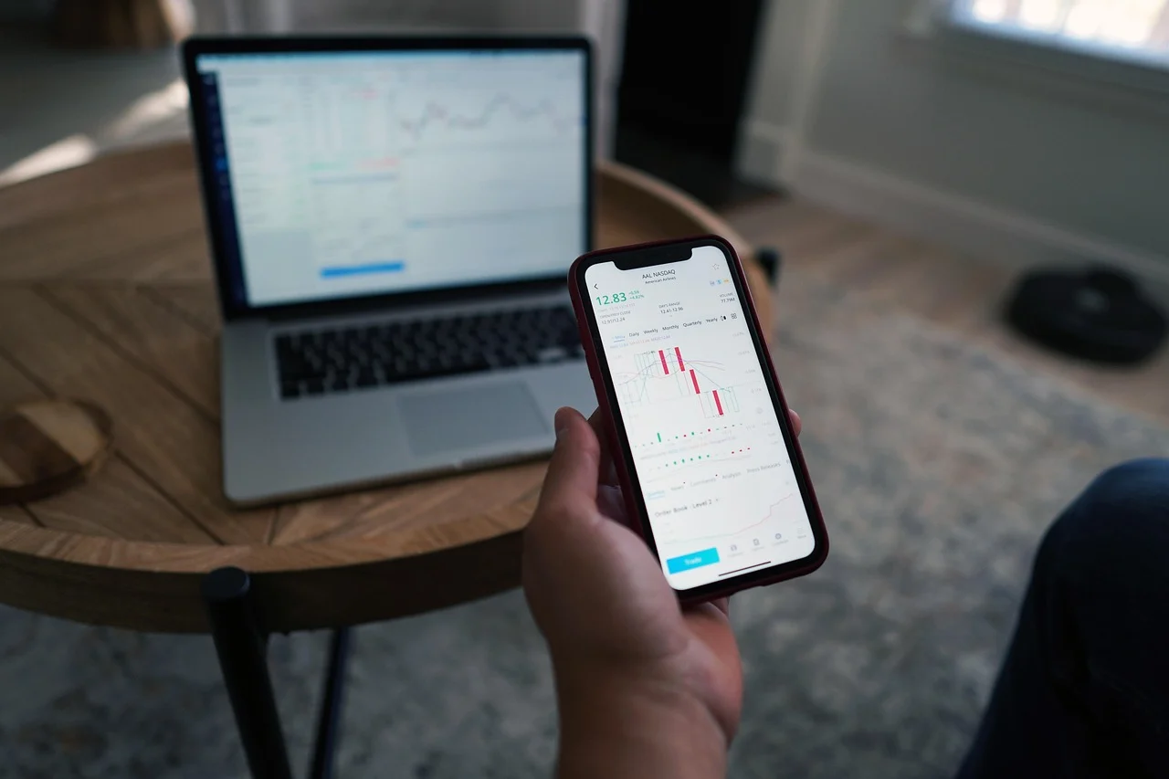 Laptop displaying an arbitrage bot dashboard with charts