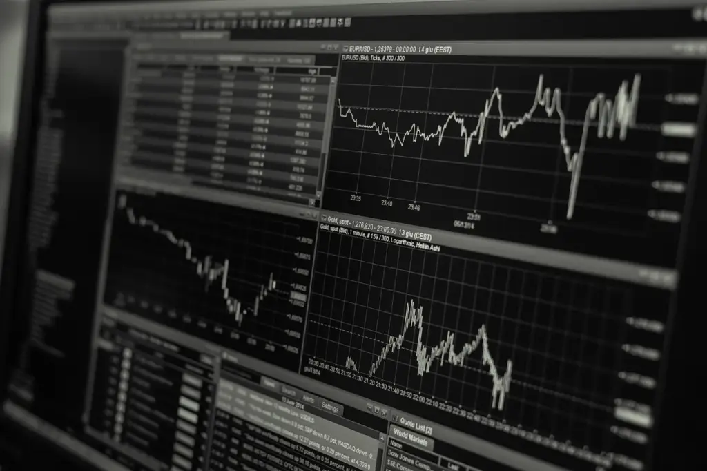 multiple monitors showing crypto exchange charts
